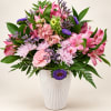 Pink and purple mixed bouquet in a white vase