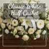 White casket spray with lilies, roses, and daisies