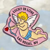 Pink cupid-shaped pin with text and a heart-tipped bow