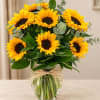 Bouquet of yellow sunflowers in a clear glass vase