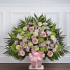 Large floral standing spray with pink roses and lavender daisies on a white stand