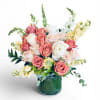 Quiet Grace features premium roses and seasonal blooms in soft blush, ivory