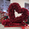 Large open heart on top of a bed of roses. A beautiful
