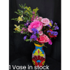 Colorful mixed flower arrangement in a painted vase