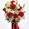 Red and white rose bouquet in a vase with a Happy Birthday topper