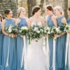 Bride and bridesmaids holding white and green bouquets outdoors