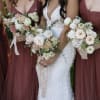 Bride and bridesmaids holding pastel wedding bouquets