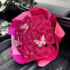 Bouquet of hot pink roses wrapped in pink paper with butterfly decorations