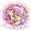 Round bouquet of pink, white, and purple flowers wrapped in lavender paper