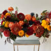 Large autumn flower arrangement in a white rectangular container