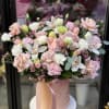 Blush and white bouquet in a pink hatbox with ribbon