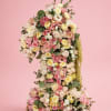 Tall floral arrangement shaped like a number one with pink and cream flowers