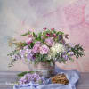 Lavender and white floral arrangement in a rustic container with loose greenery