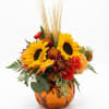 Autumn floral arrangement with sunflowers in an amber vase