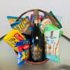 Basket of snacks with a bottle of prosecco