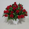 Red roses arranged in a white vase