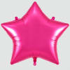 Pink star-shaped foil balloon on a plain background