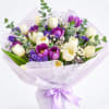 Bouquet of purple and white tulips wrapped in lavender paper