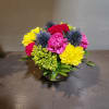 Colorful mixed flower arrangement in a low glass bowl