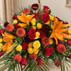 Large bouquet of red, yellow, and orange flowers in a room