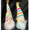Two small gnome figurines with tall patterned hats and fluffy beards