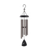 Black and silver wind chime hanging on a white background