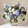 Blue and white flower arrangement in a clear glass vase
