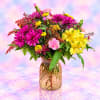 Colorful bouquet of pink, yellow, and purple flowers in a gold vase