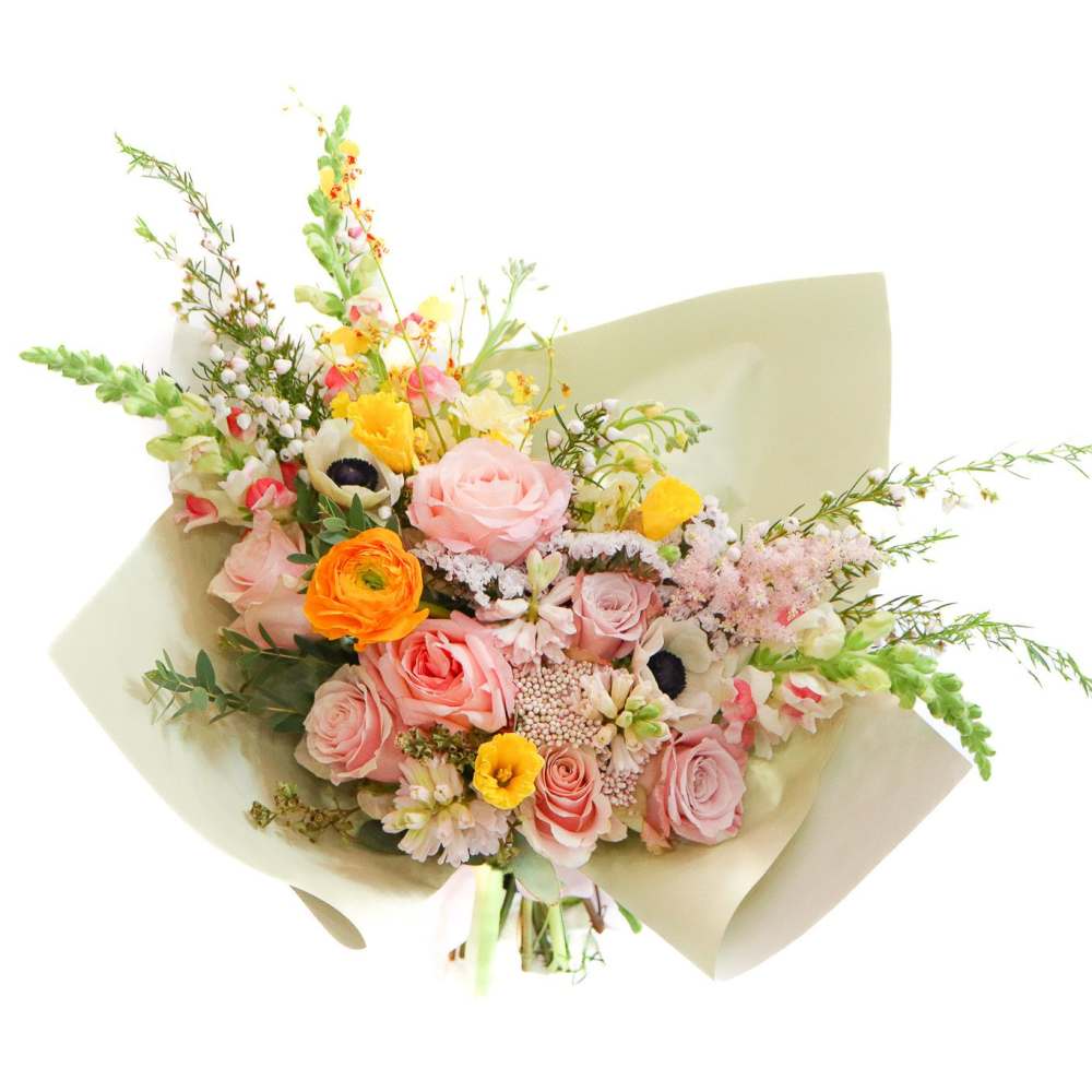 Bouquet of pink and orange flowers wrapped in pale paper