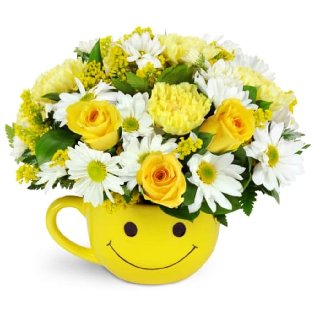 Yellow smiley-face mug filled with yellow roses and white daisies