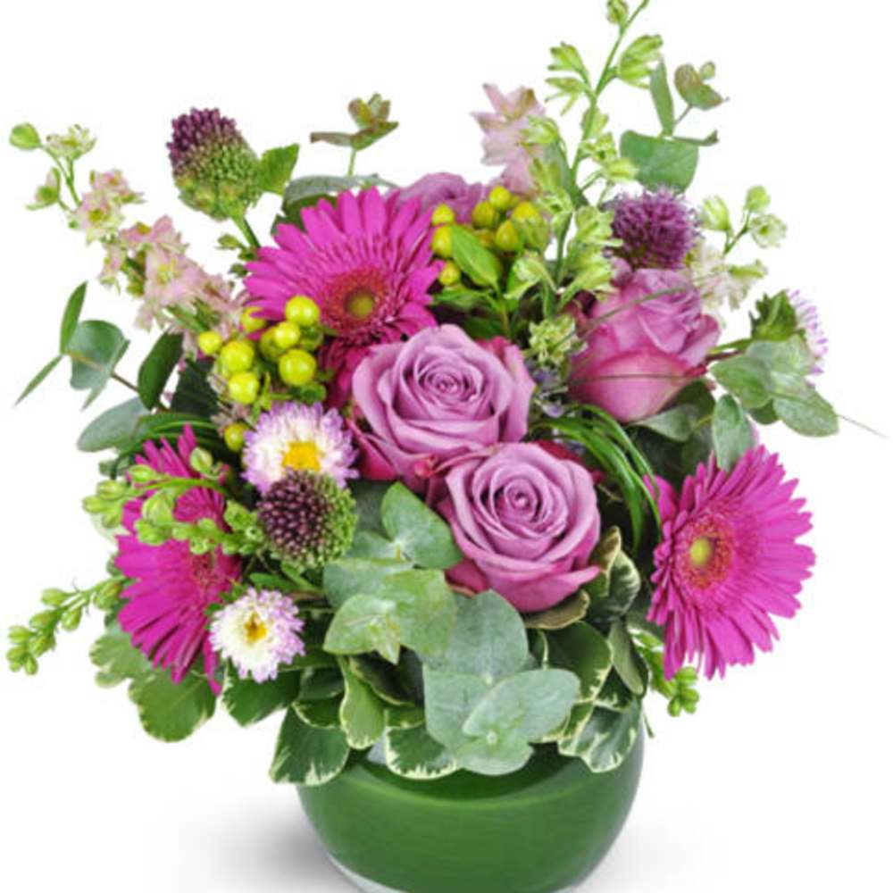 Pink and lavender bouquet in a green glass vase