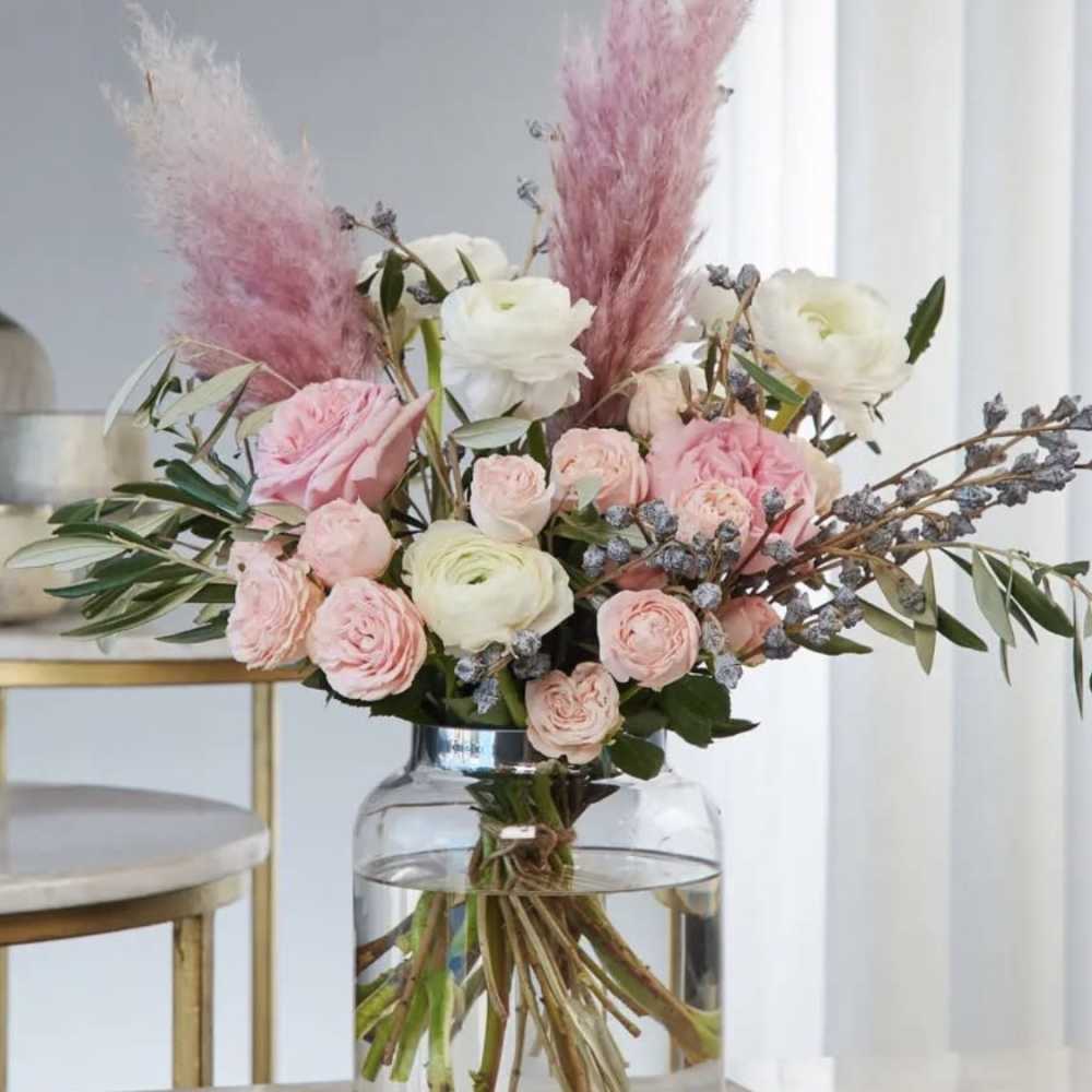 Pink and white floral arrangement in a clear glass vase
