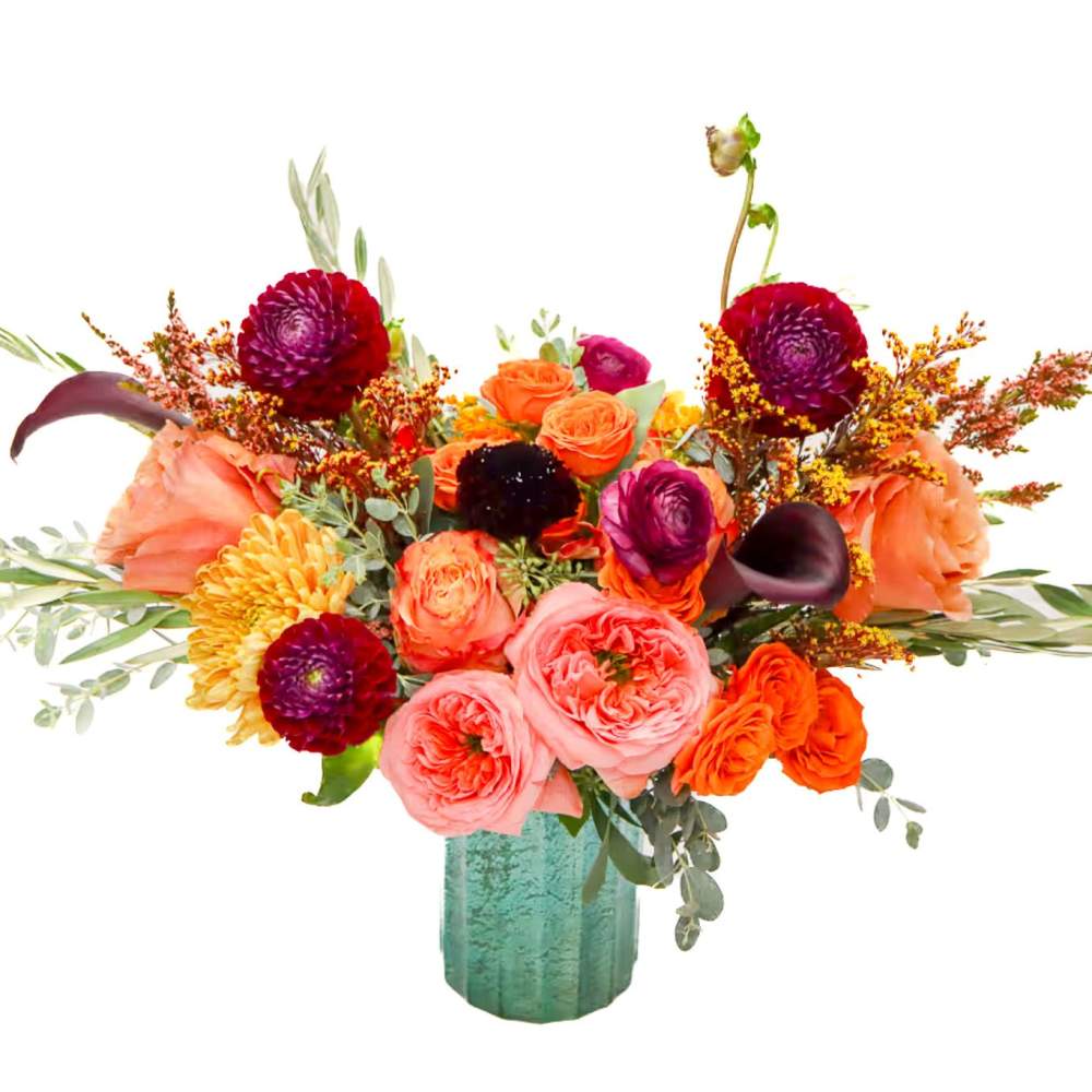 Bright mixed bouquet in a teal vase with roses and orange blooms