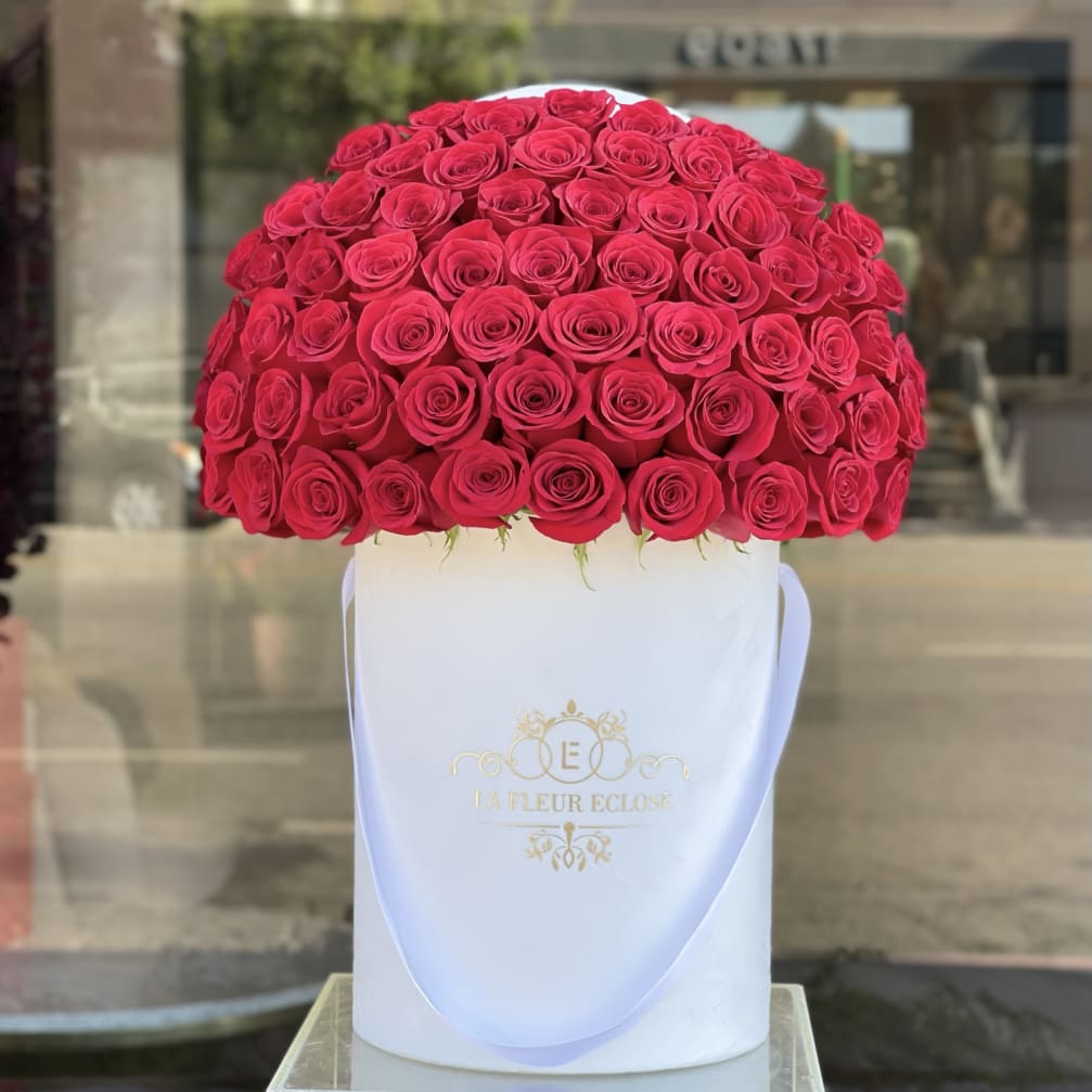 Large dome of red roses in a white hatbox