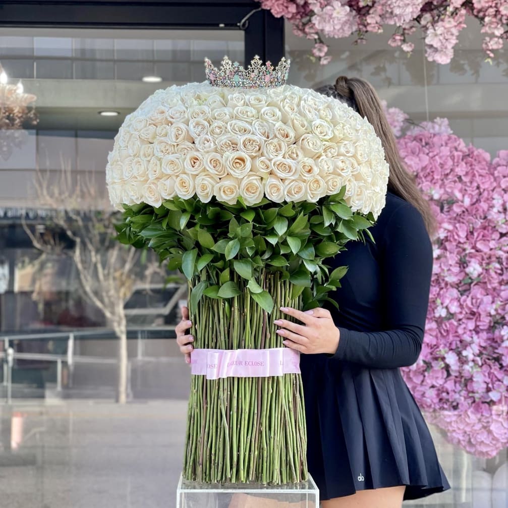 Large dome bouquet of white roses with a jeweled crown on top