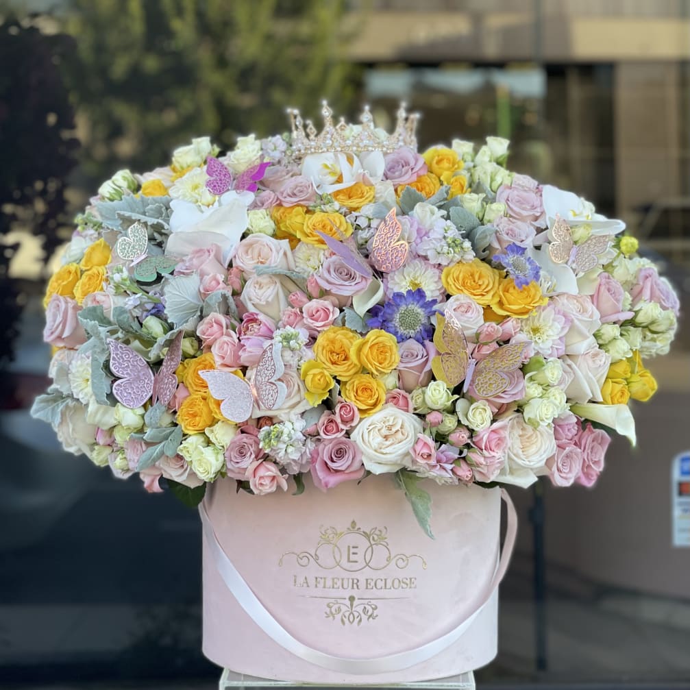 Large pastel rose bouquet in a pink hat box with butterfly accents