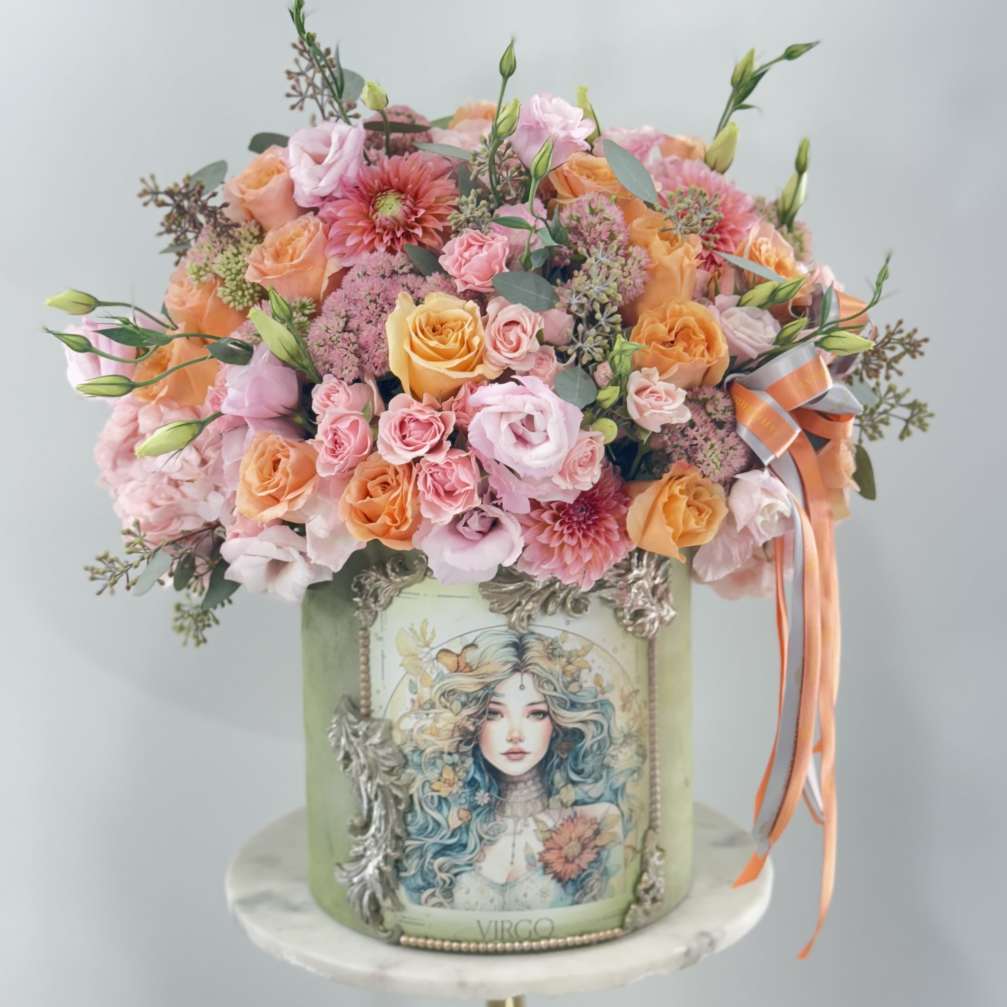 Mixed pink and peach bouquet in a decorated green box with ribbon