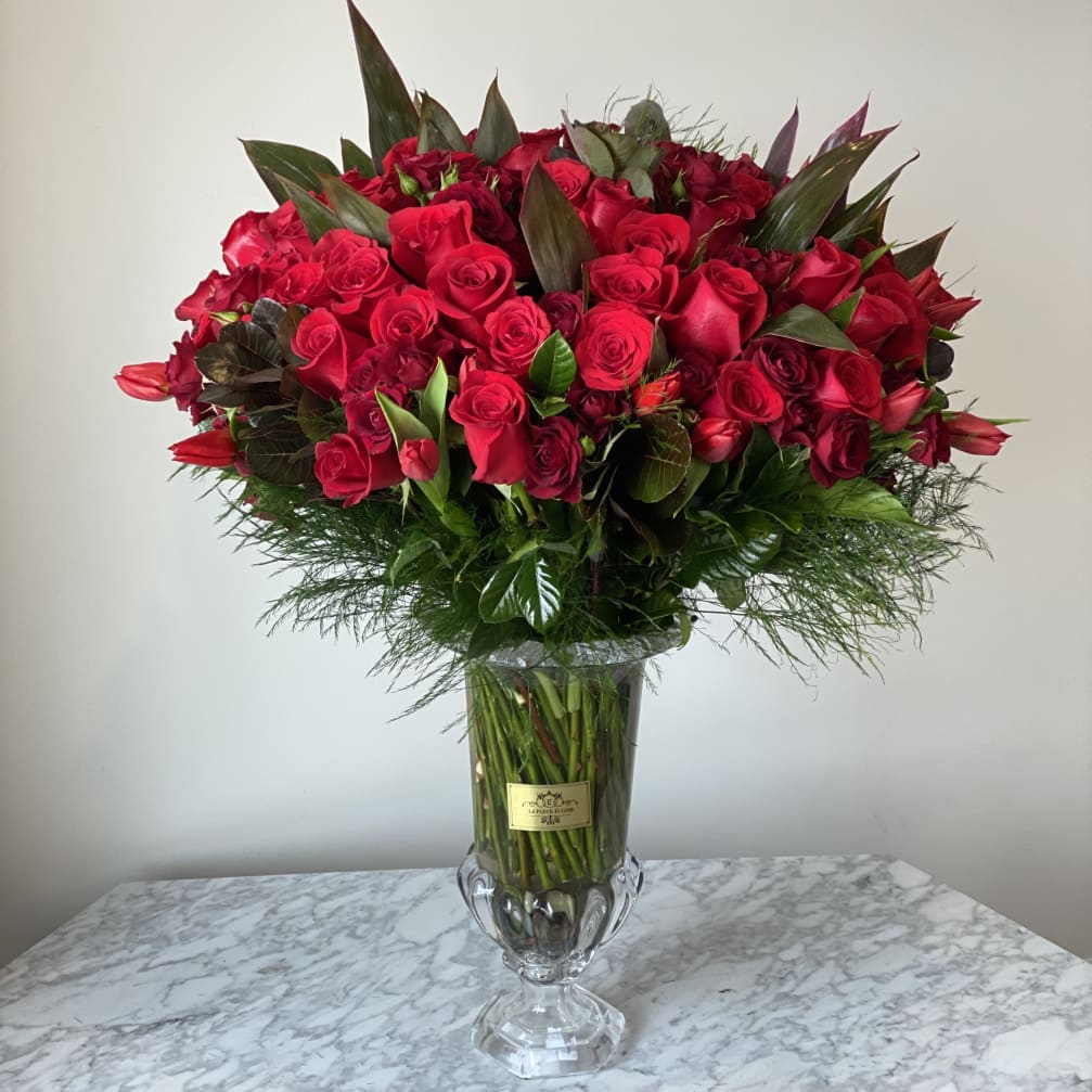 Large bouquet of red roses in a clear glass vase