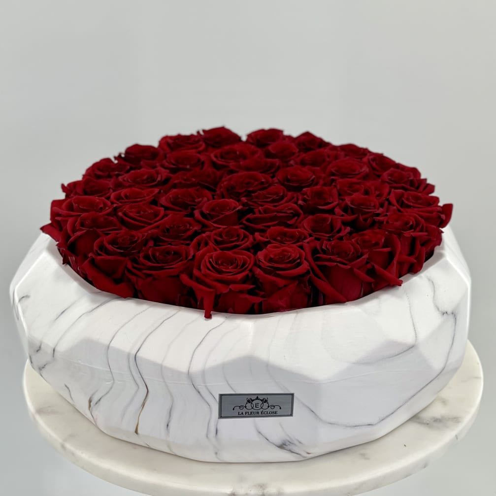 Round box filled with red roses