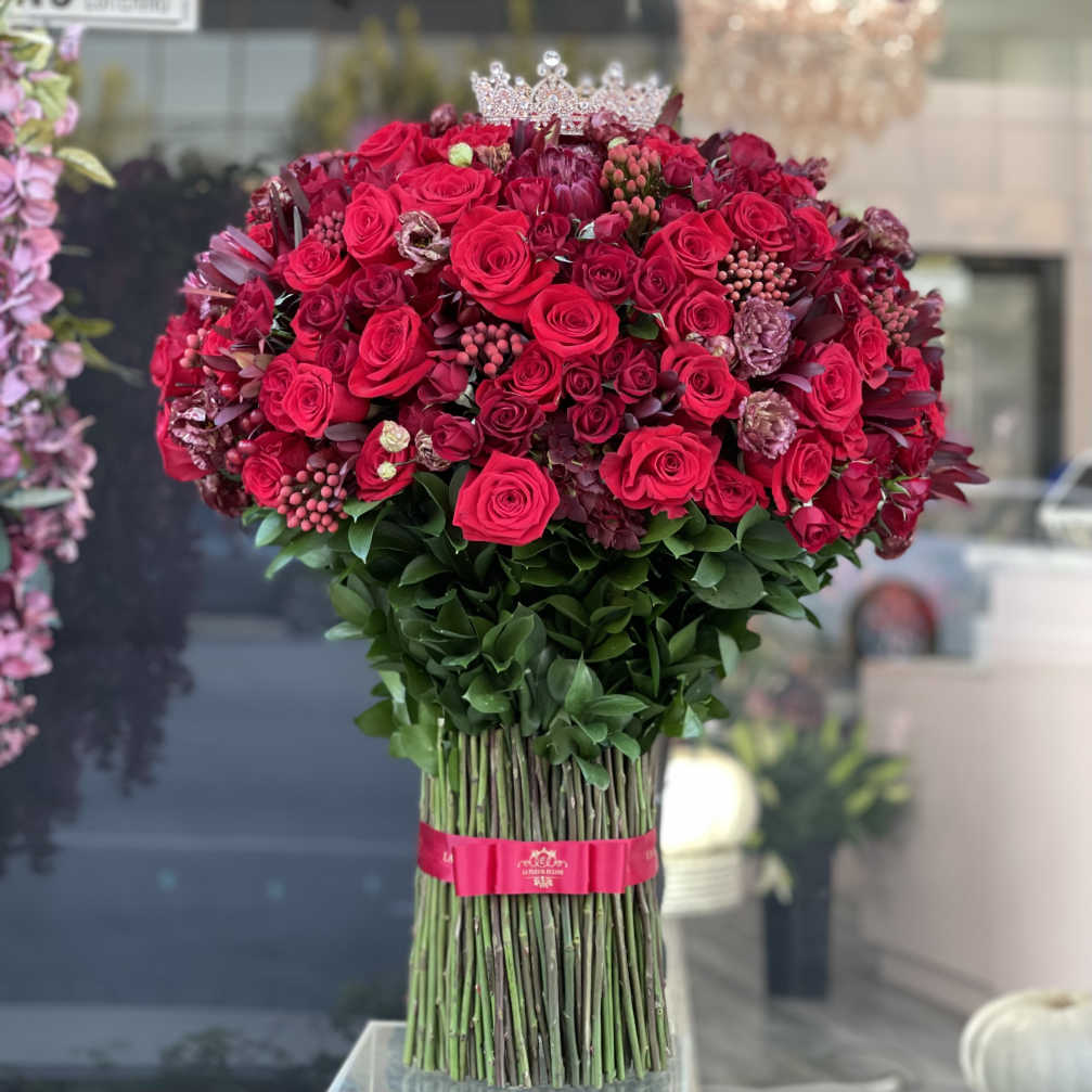 Large bouquet of red roses with a jeweled crown topper