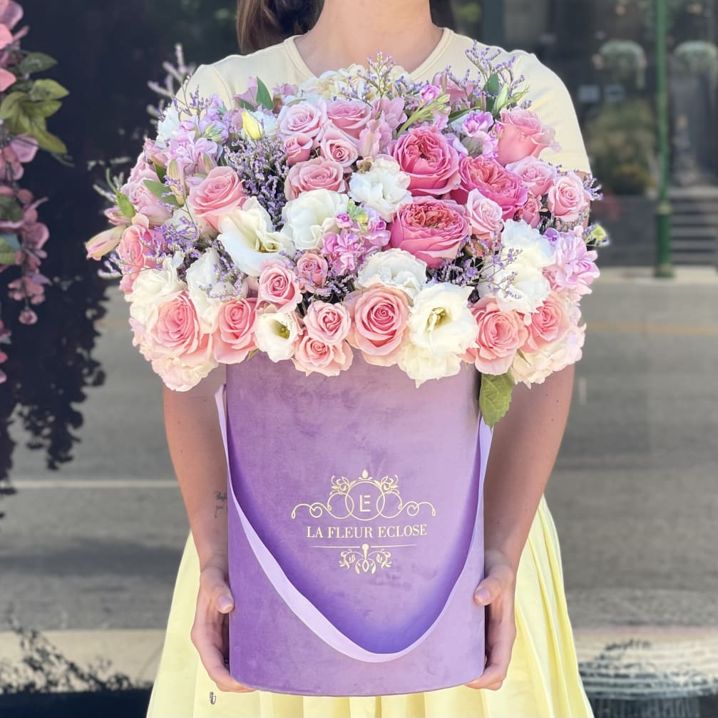 Large pink and white rose bouquet in a purple gift box