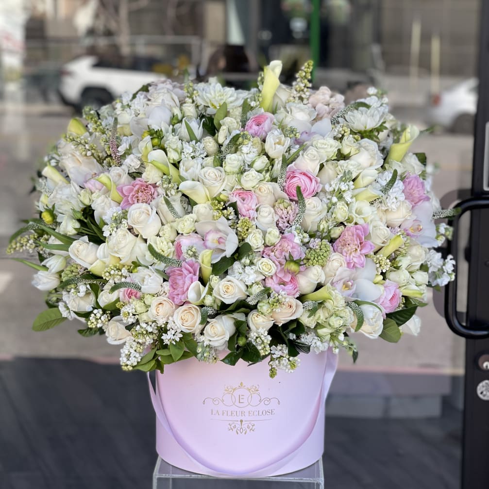 Large pastel bouquet in a pink hatbox with white and pink flowers