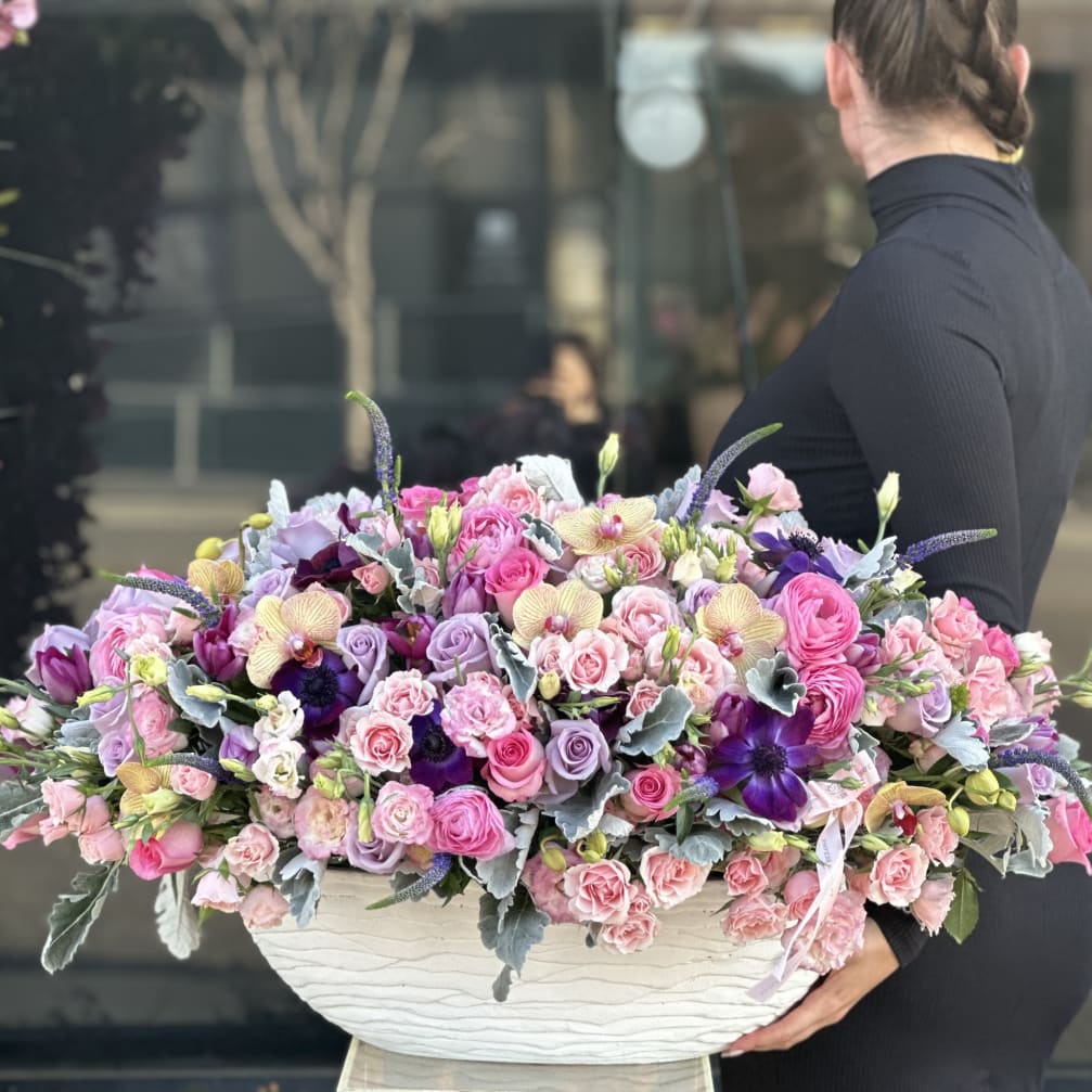 Large pastel bouquet in a white textured container