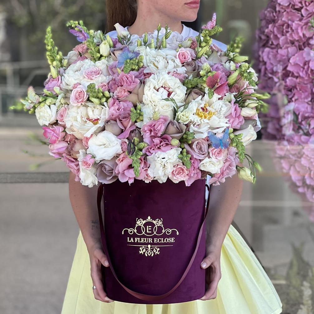Large pastel bouquet in a burgundy hatbox