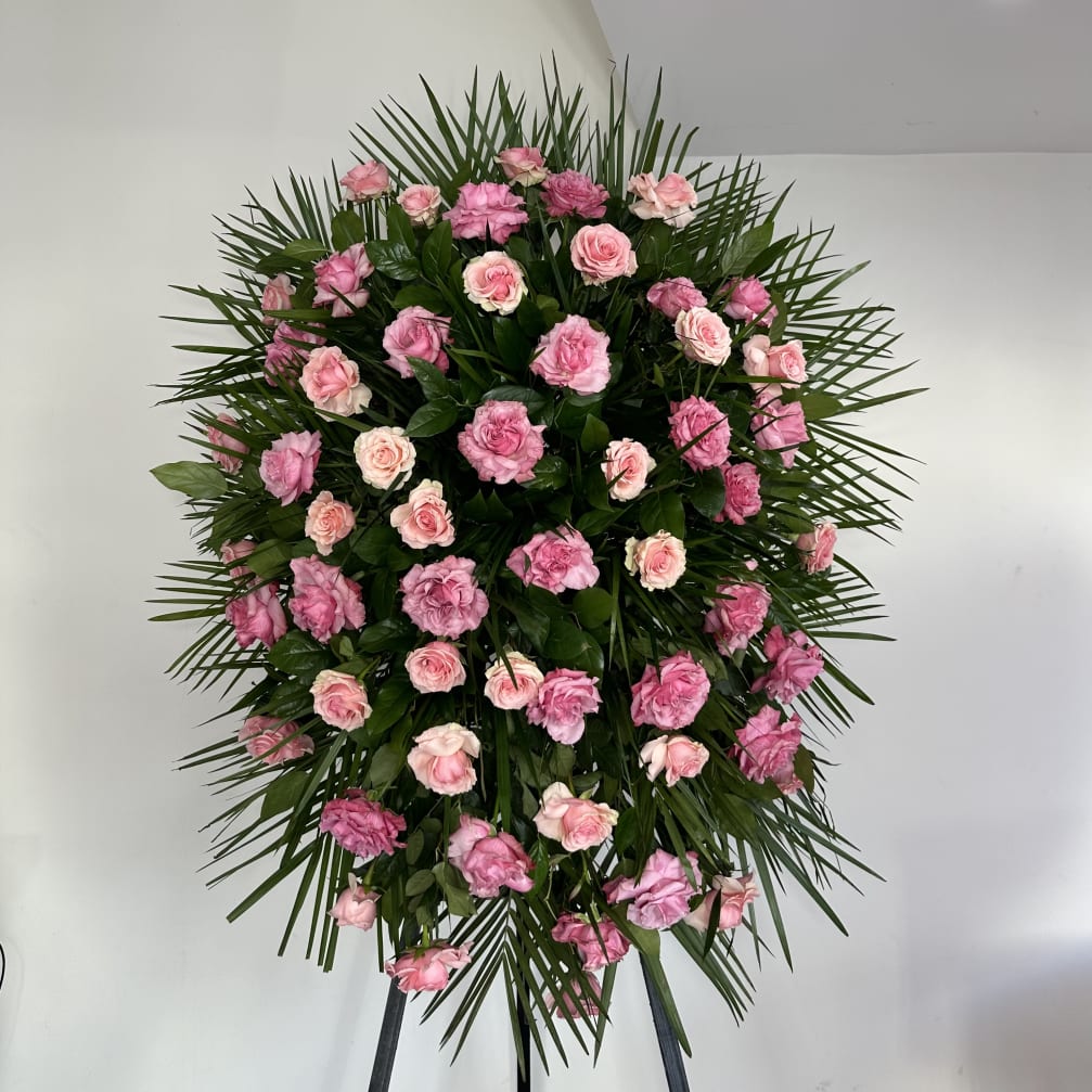 Standing spray of pink roses with palm fronds