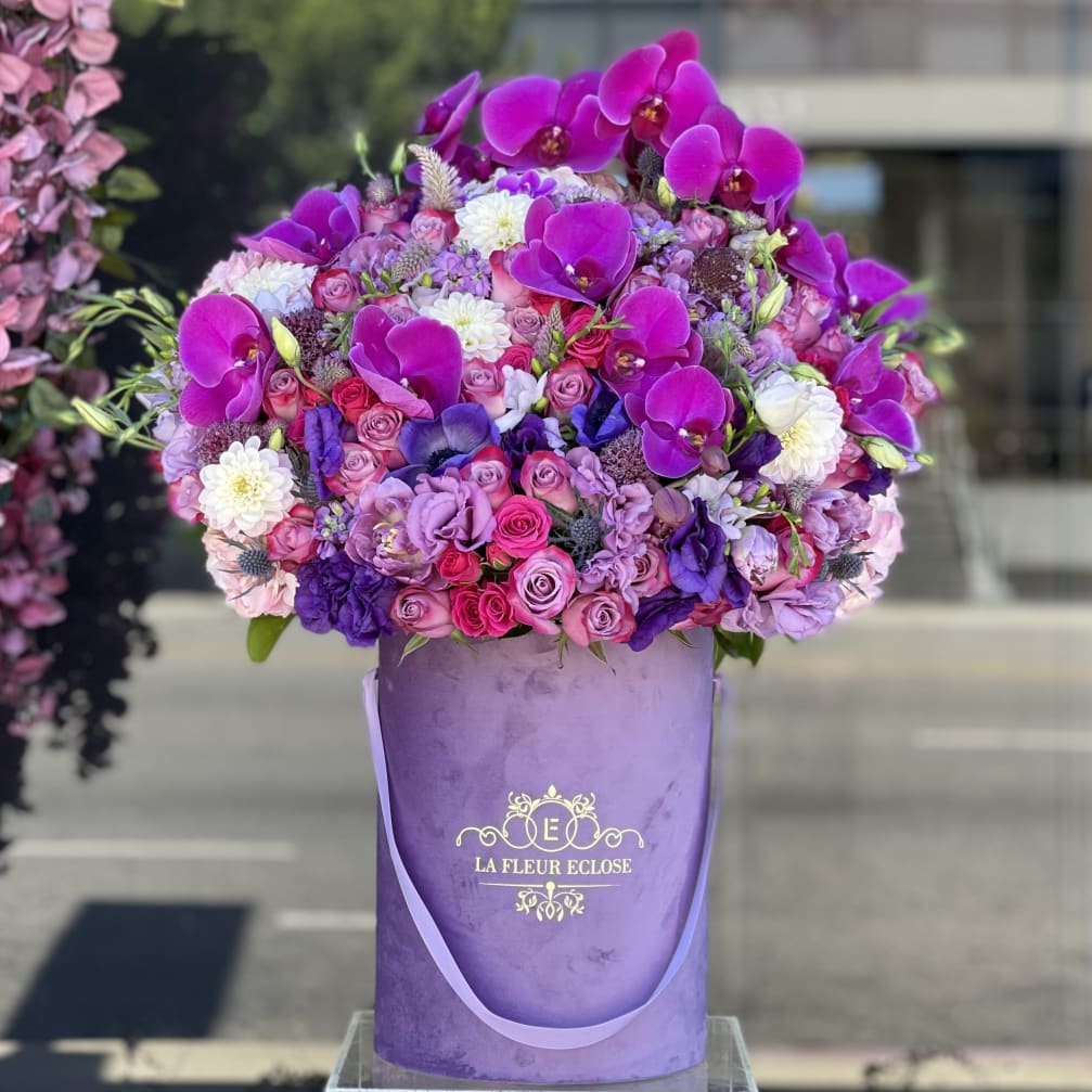 Large purple floral arrangement in a lavender hatbox