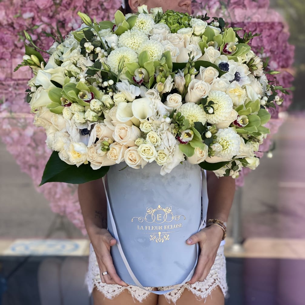 Large bouquet of white and pale green flowers in a blue gift box