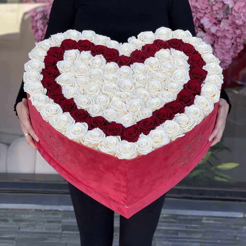 Heart-shaped box filled with red and white roses
