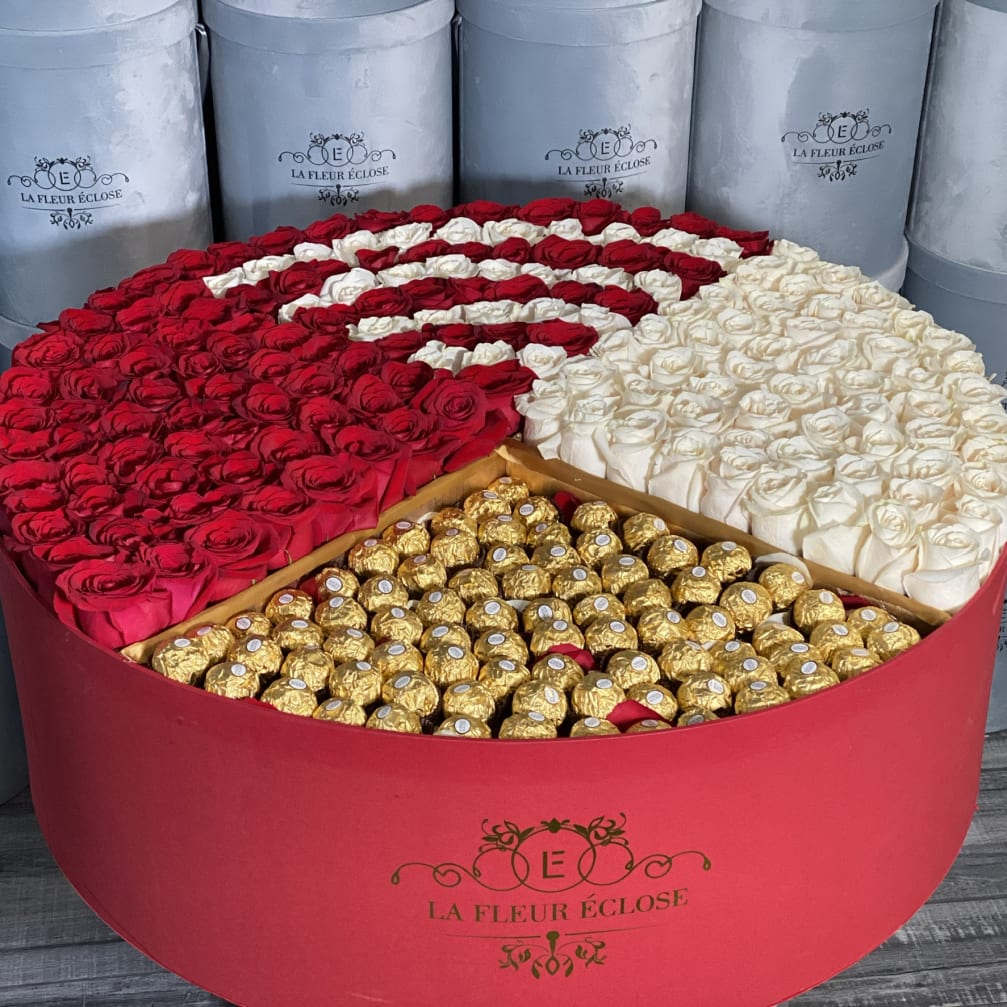 Heart-shaped box of red and white roses with gold chocolates