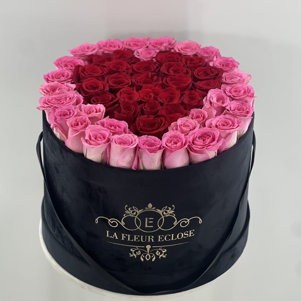 Round box of pink and red roses